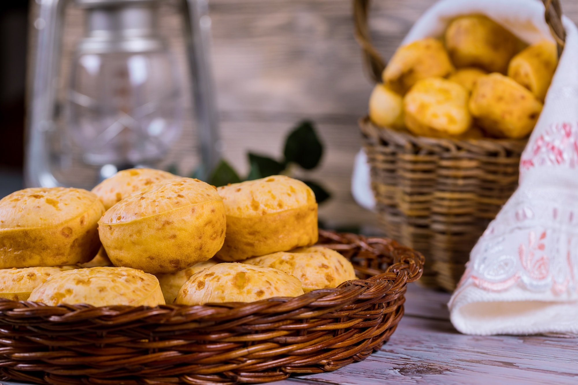 Brazilian cheese bread, chipa in basket on table.