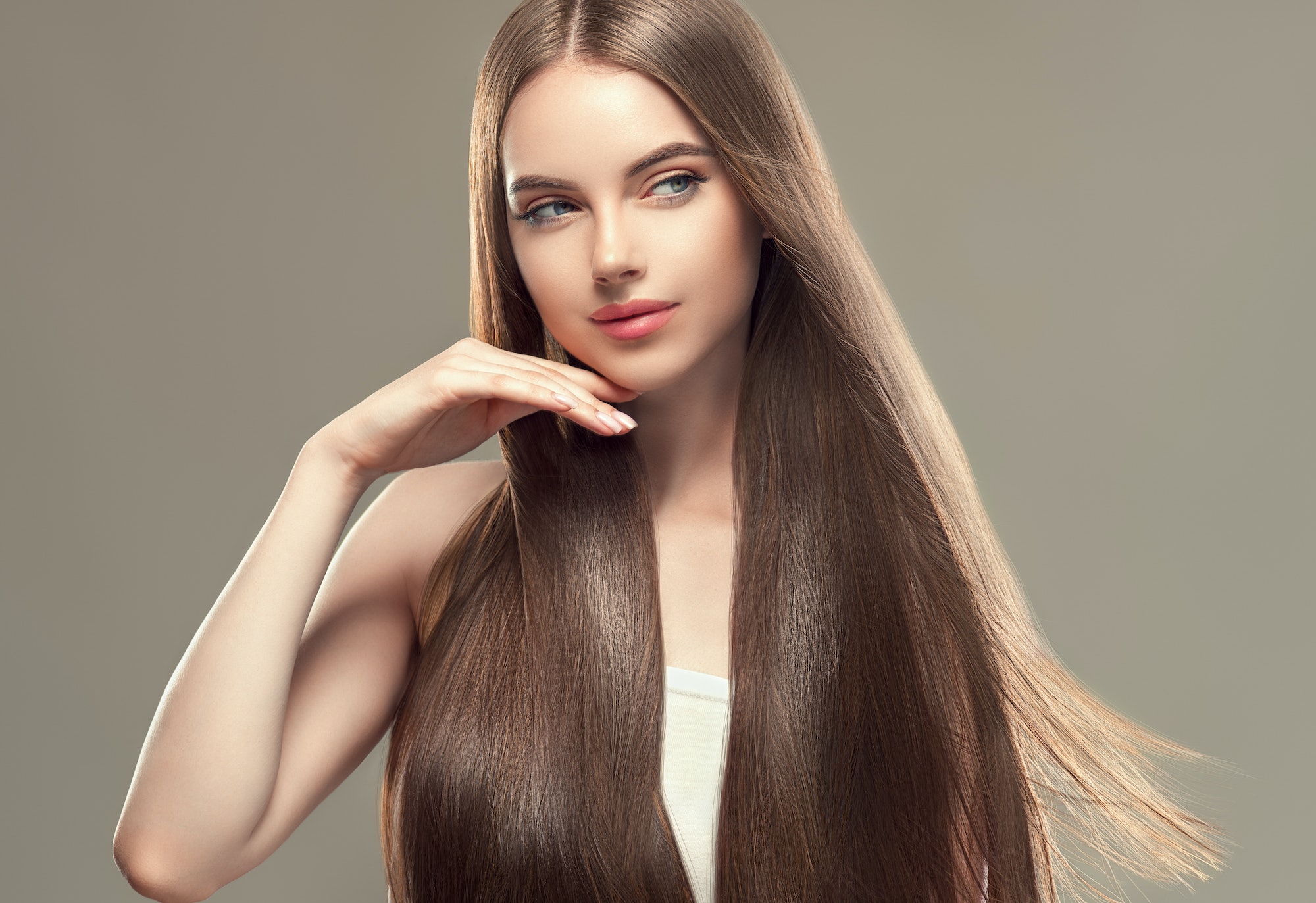 Woman with long smooth hair beautiful hairstyle fashion make up